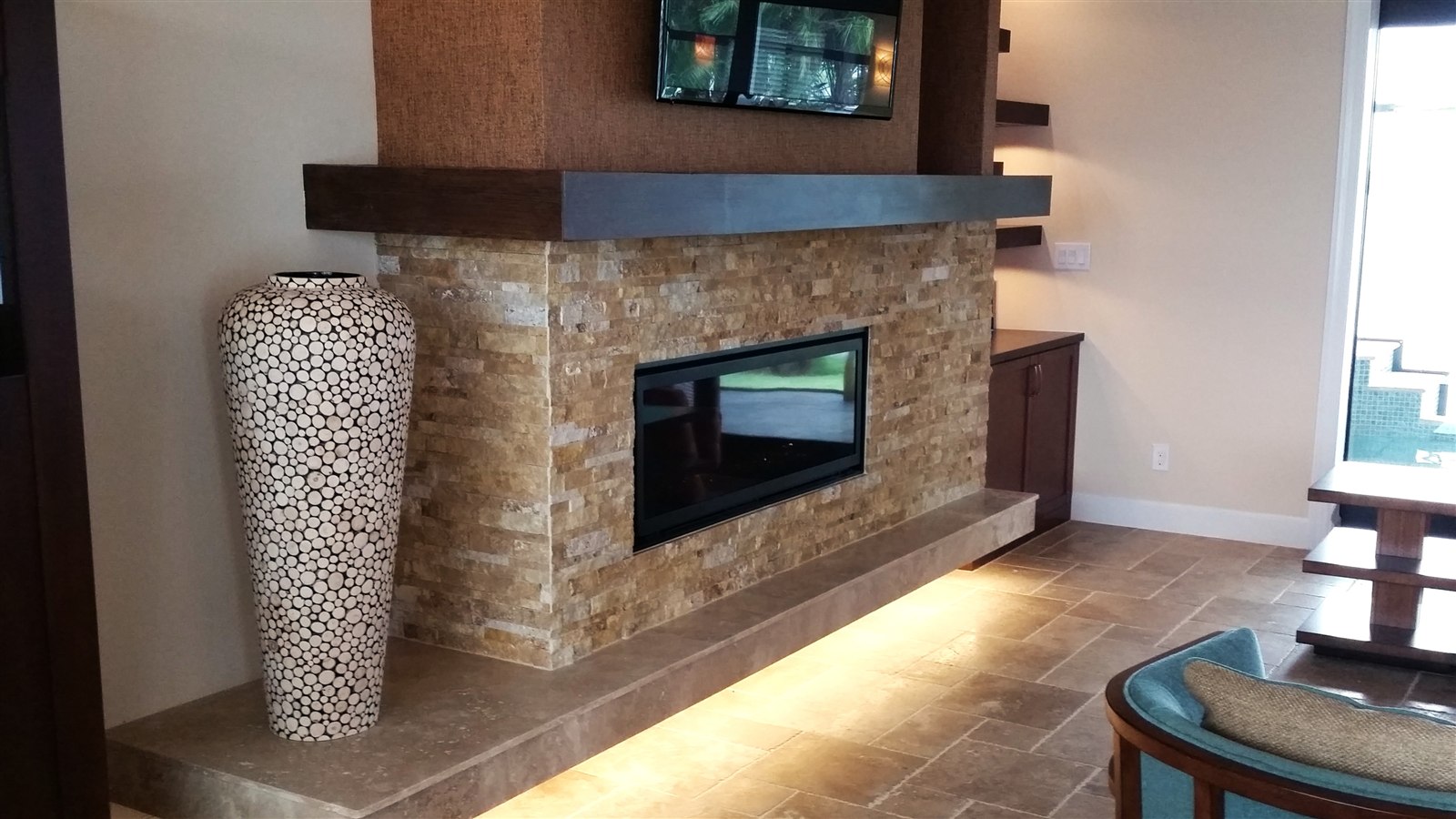Stacked-stone fireplace with tile flooring, Hattiesburg MS living room